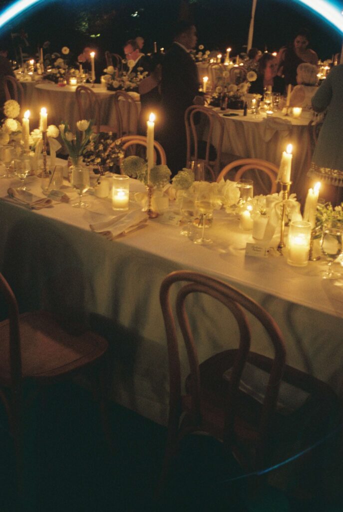 Details of candles lighting the reception tables outside