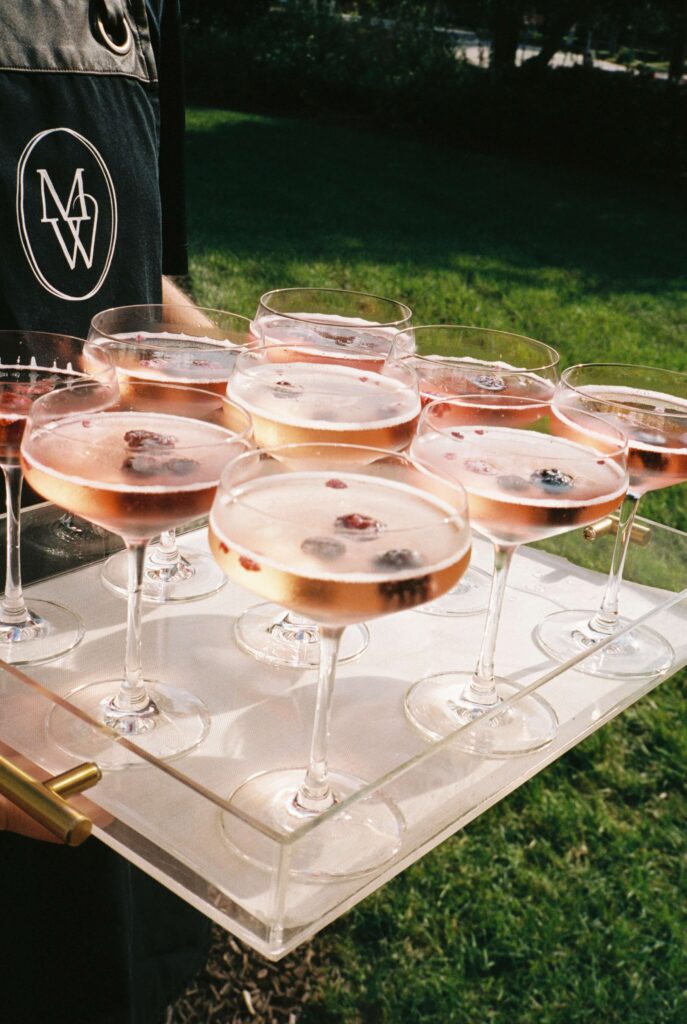 Details of raspberry cocktails on a serving tray