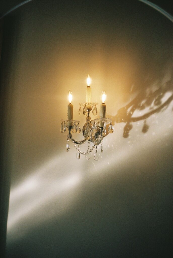 Details of a candle sconce on a wall with crystal