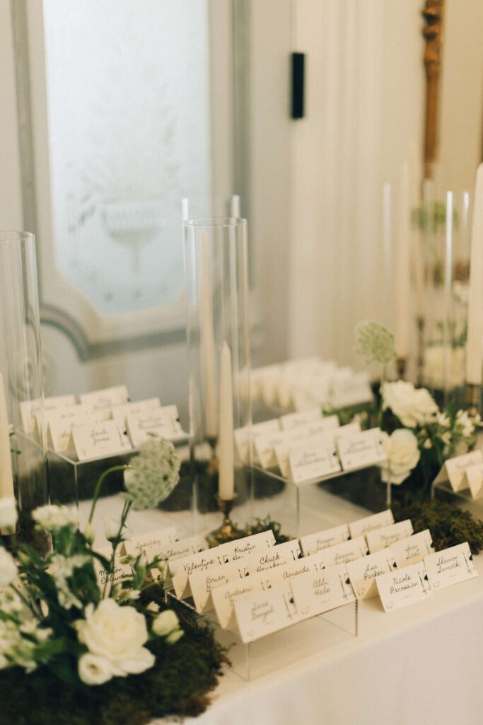 Details of name cards on a table with candles at a merrimon wynne house wedding