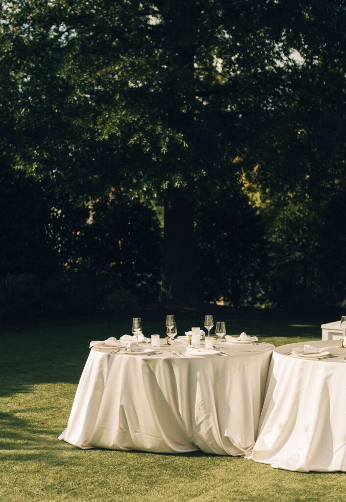 A peak at reception table sset up in the lawn for a merrimon wynne house wedding reception