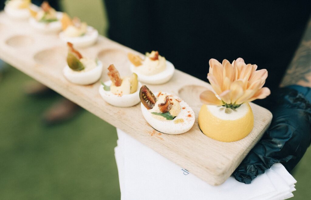 Details of a deviled egg platter held by a waiter