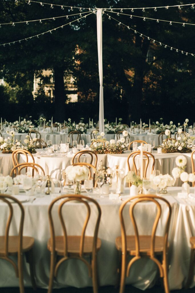 Details of a merrimon wynne house wedding reception set up in the lawn with white linen and roses
