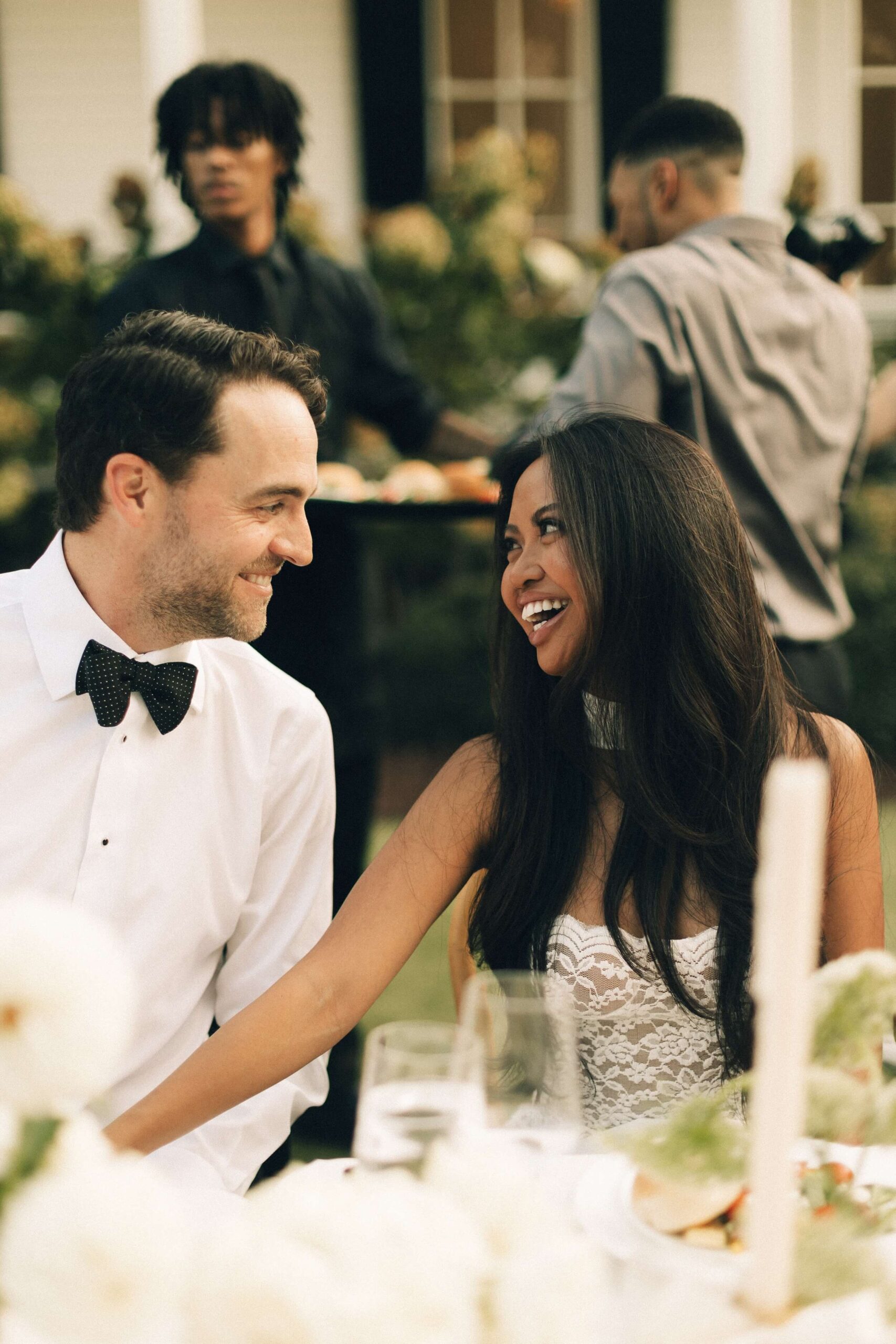 Newlyweds share a laugh at their outdoor merrimon wynne house wedding reception