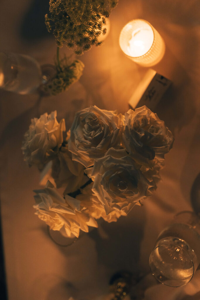 A merrimon wynne house wedding reception table with white roses and candles