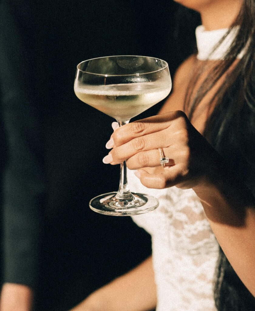Details of a bride holding a glass of wine