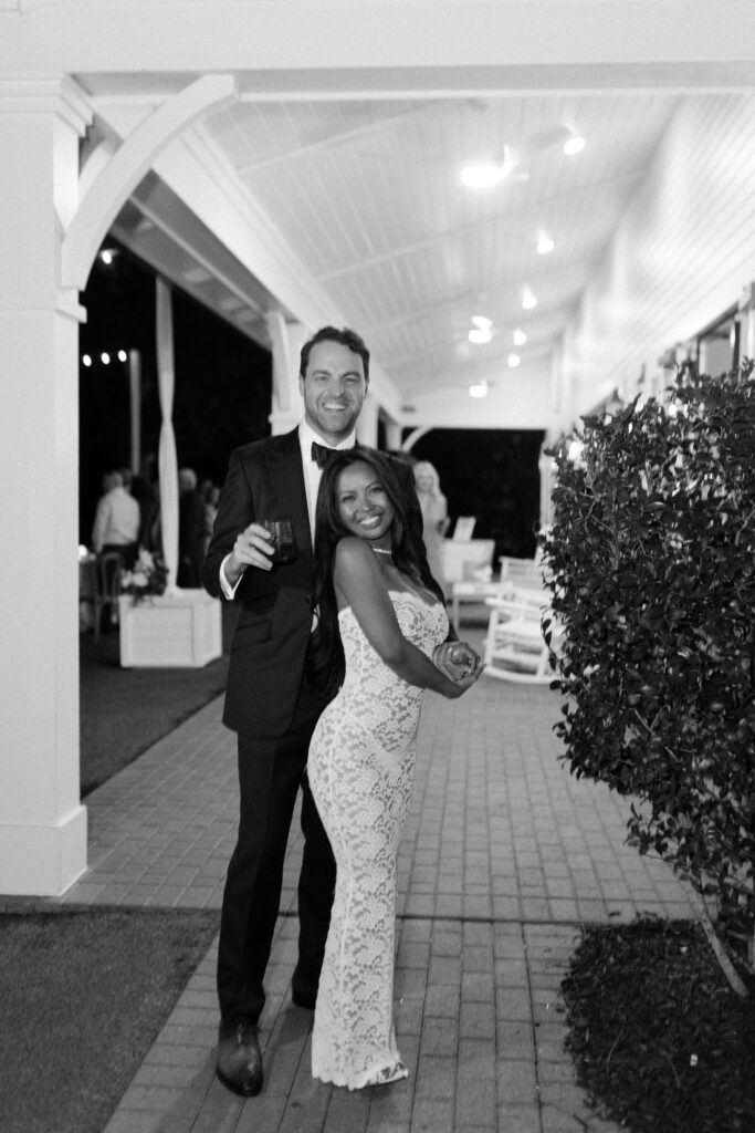 Newlyweds snuggle on the brick patio of the merrimon wynne house wedding venue