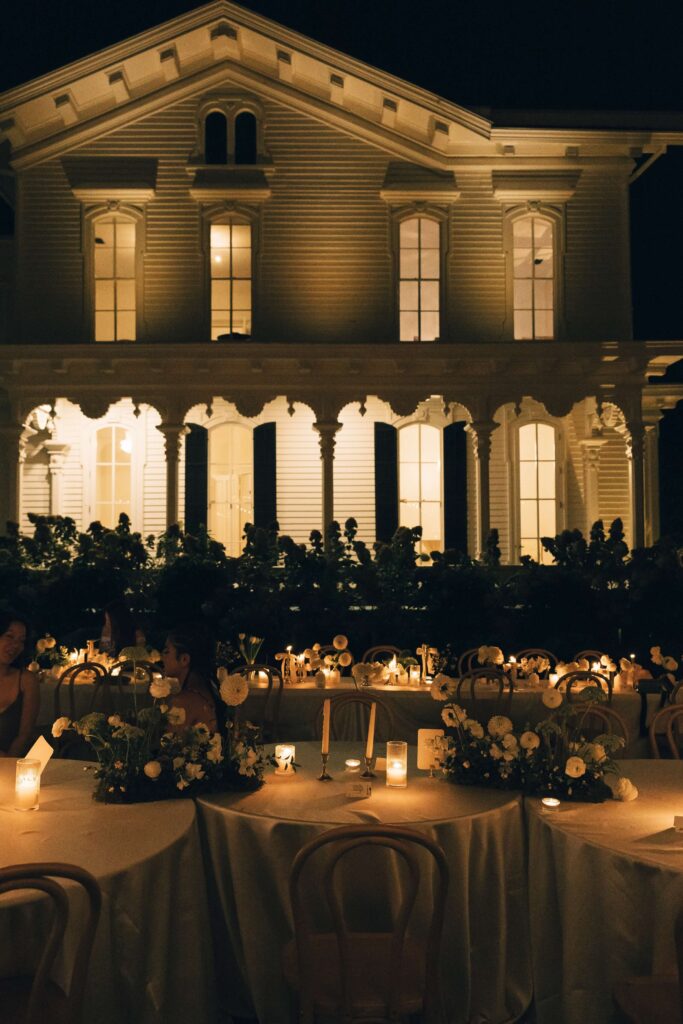 Details of an outdoor wedding reception set up with candles in the merrimon wynne house wedding venue lawn