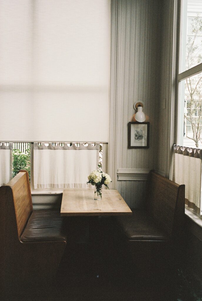 A peak at a quiet wooden booth table at the Post House Inn wedding venue