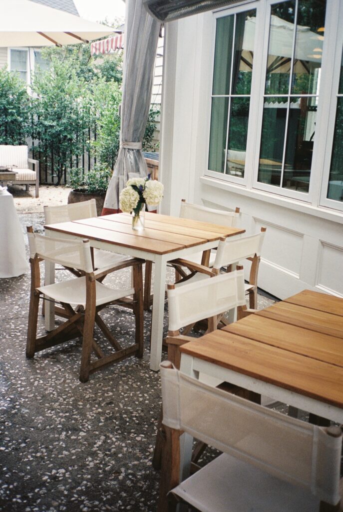 Details of the patio with white flowers and patio furniture of the Post House Inn wedding venue