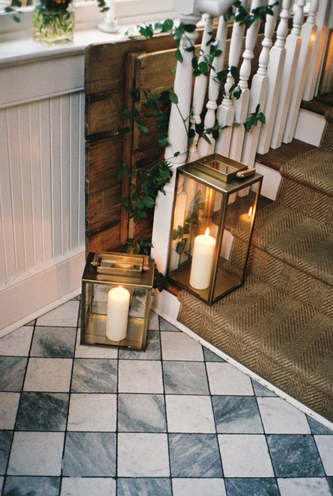 Details of candles in glass boxes on the stairs of the Post House Inn wedding venue