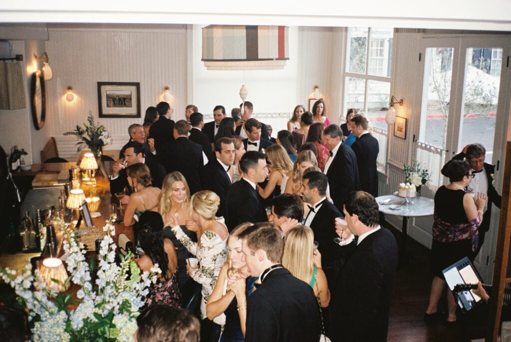 A look down over a bustling wedding cocktail hour at the Post House Inn wedding venue bar