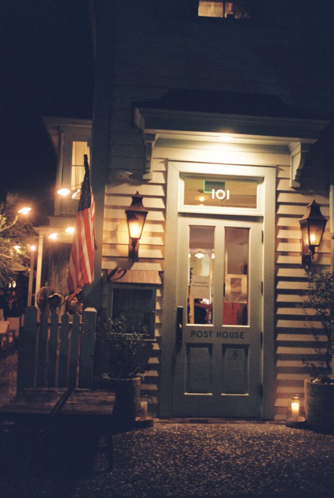 A look at the main entrance of the Post House Inn wedding venue at night with lights on