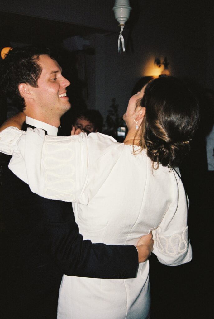 Newlyweds dance and play on a dark dance floor