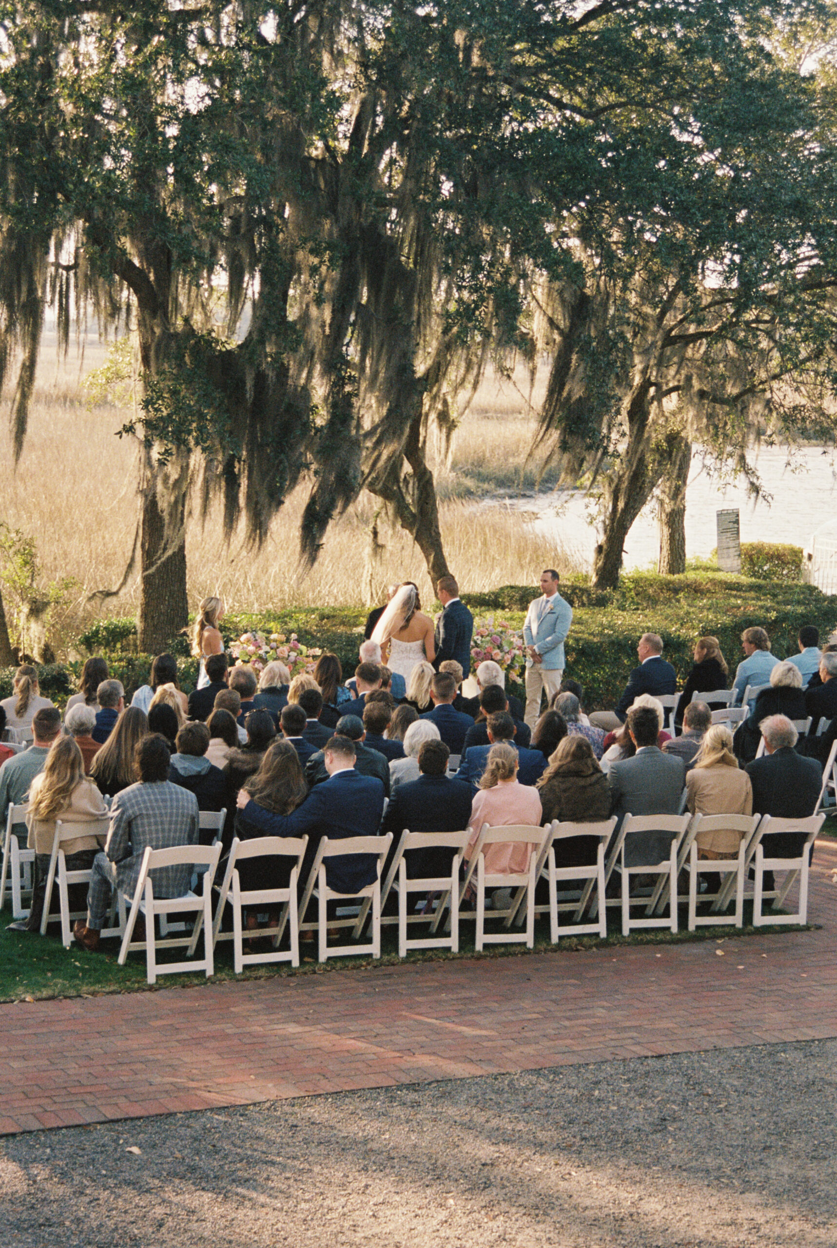 A peak at an outdoor ceremony under the live oaks by the water at one of the Wilmington wedding venues