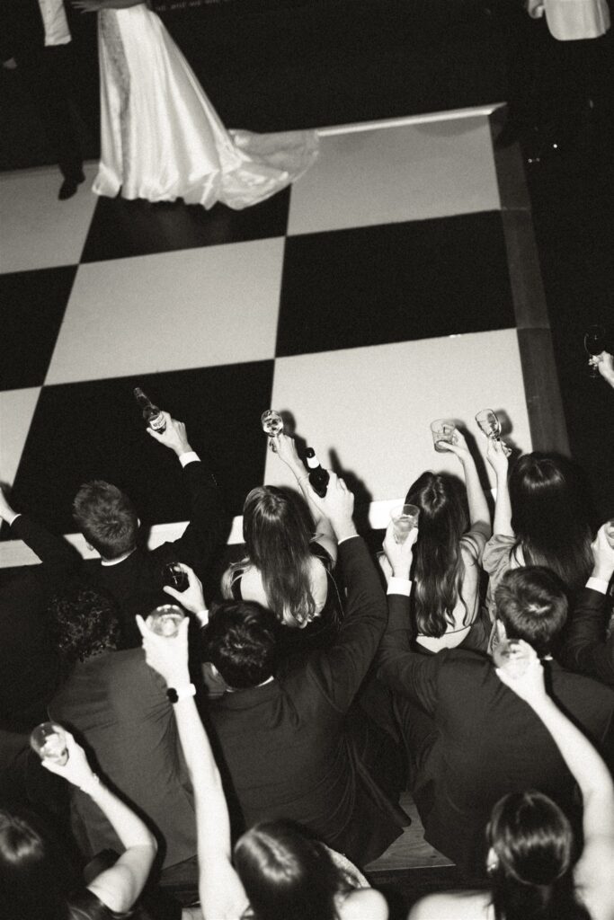 Wedding guests raise a glass to the dancing bride and groom on the dance floor at one of the Wilmington wedding venues