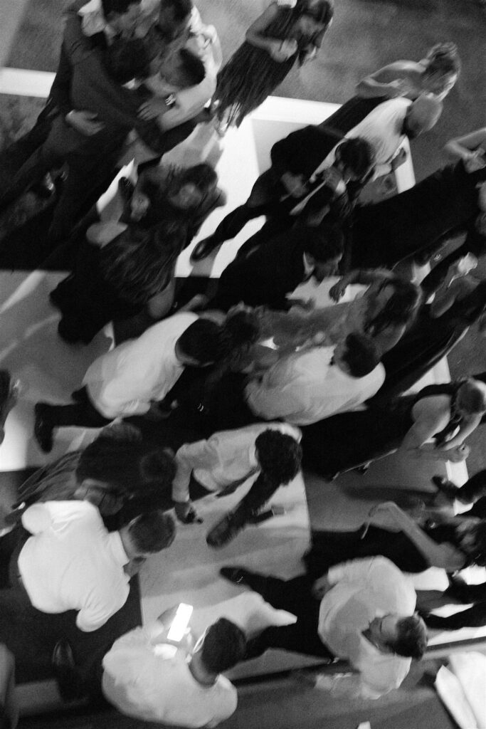 A look down onto a lively dance floor in black and white during a wedding