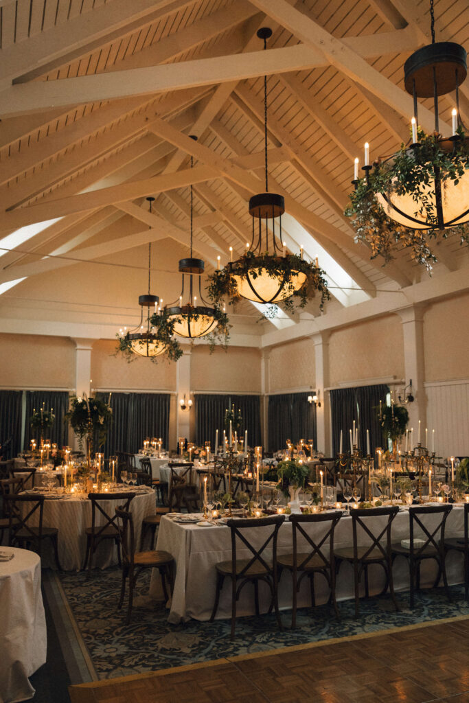 A look at a montage palmetto bluff wedding reception set up under the chandeliers and exposed wooden beams