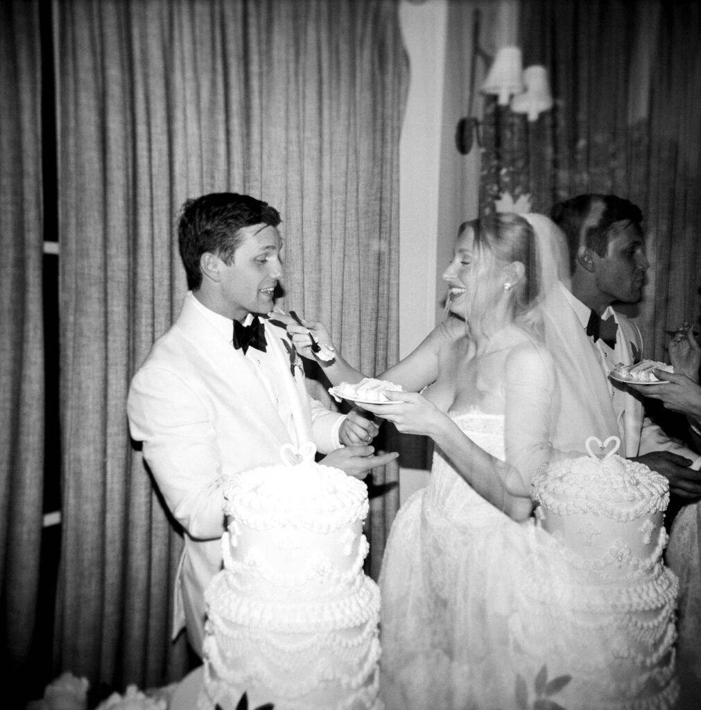 A bride wipes cake of a groom's face after their cutting at the montage palmetto bluff