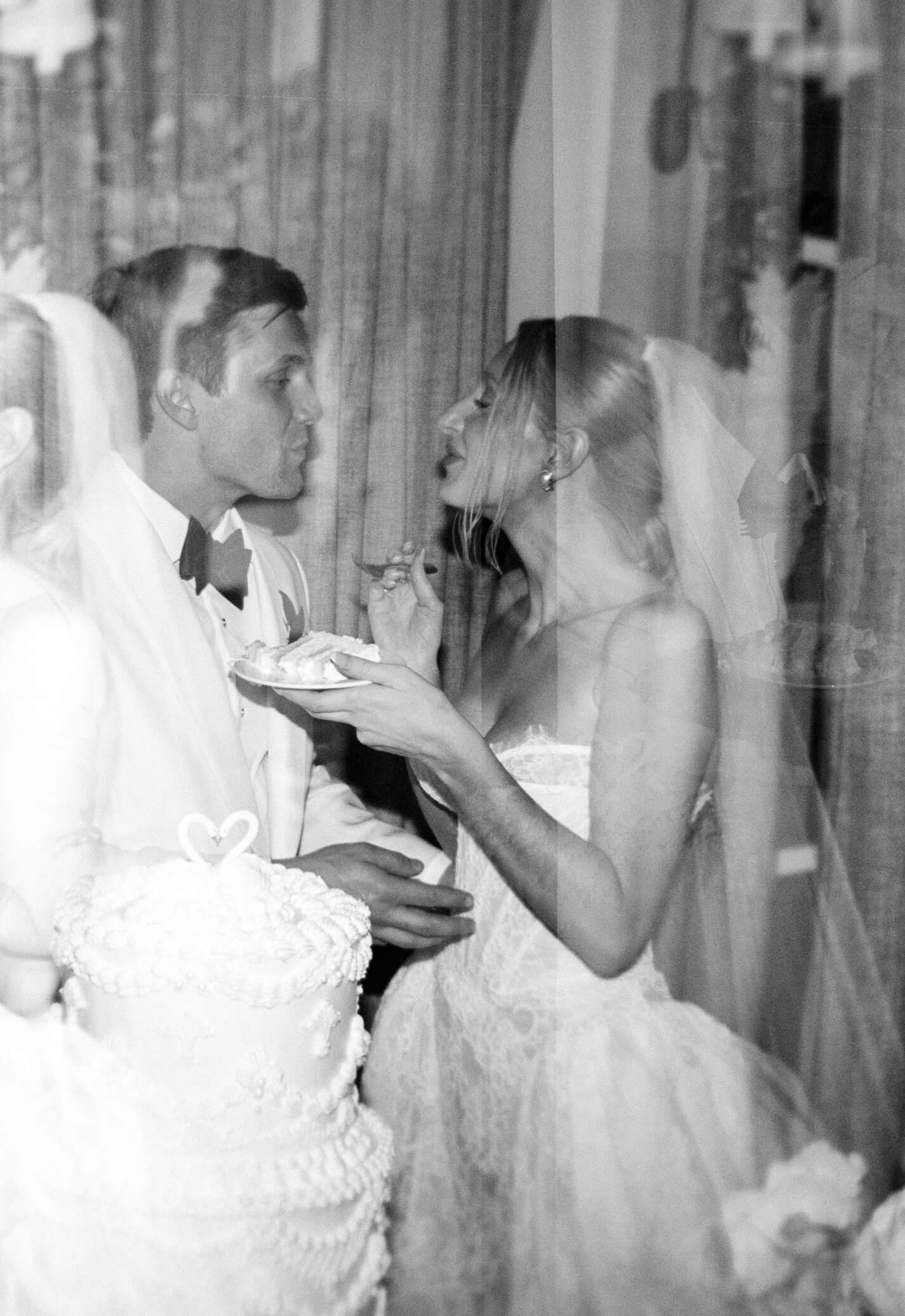 Newlyweds share a slice of cake right before a kiss at the montage palmetto bluff